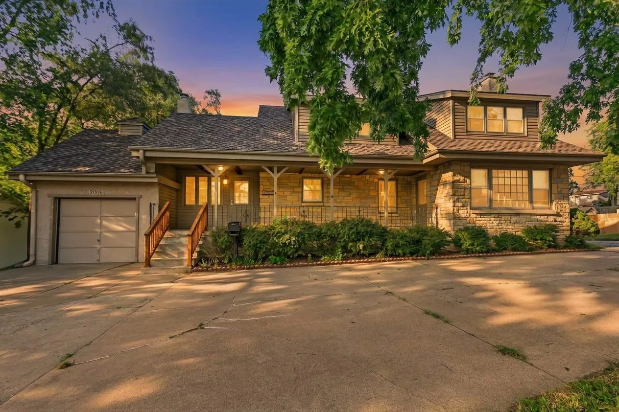 The house at twilight with warm porch lights
