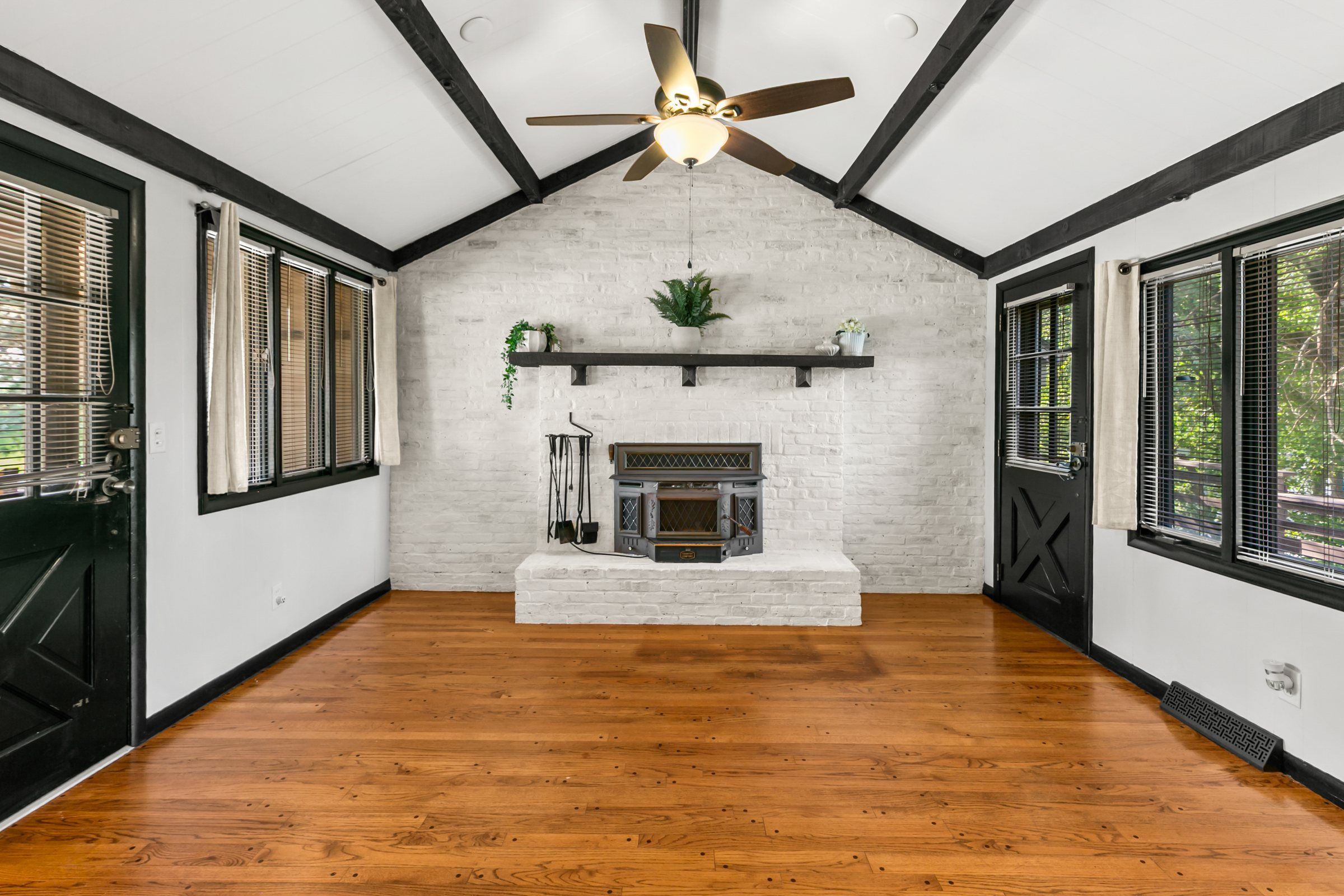 A bright living room with a vaulted, beamed ceiling