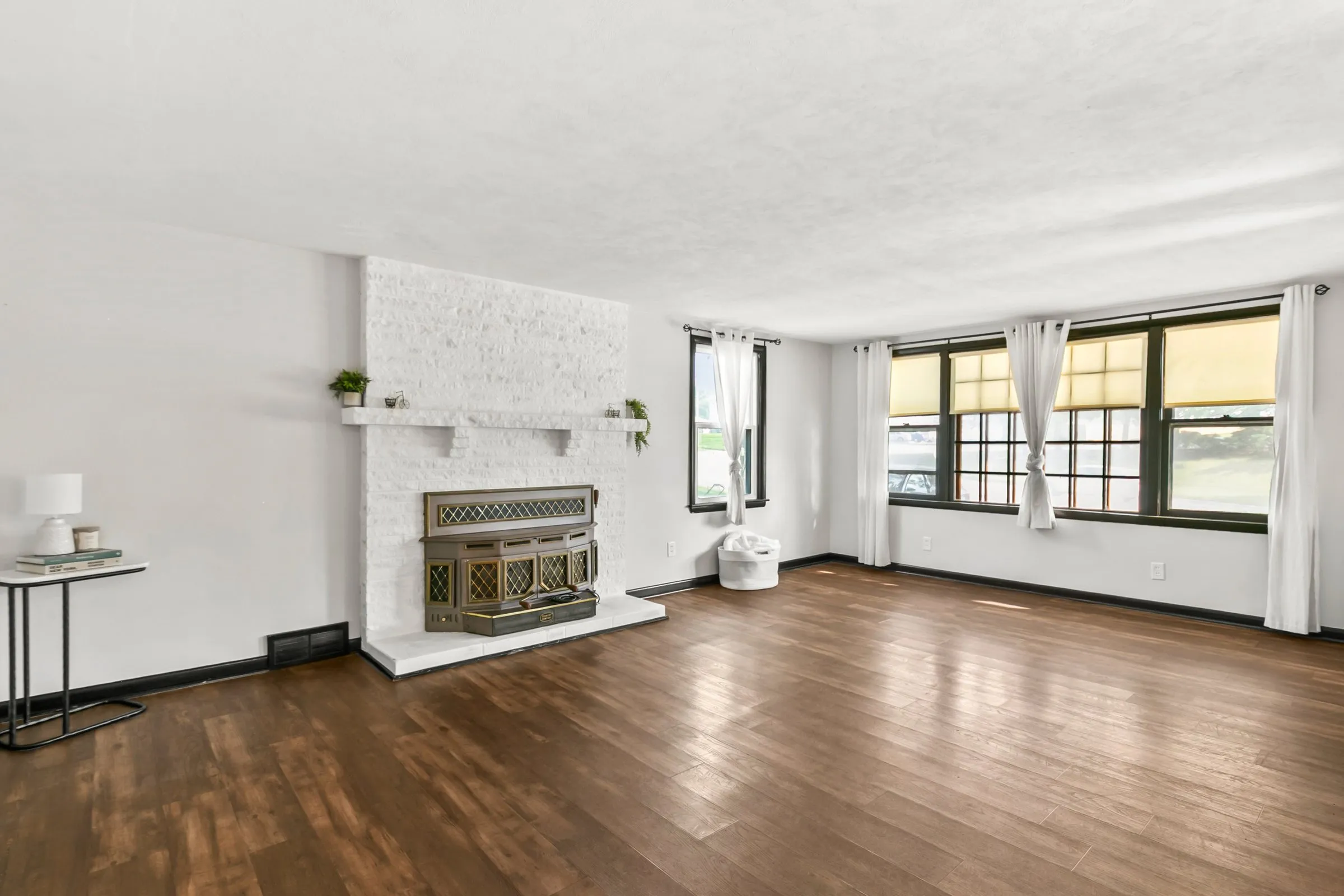 Second living area with fireplace and wood floors